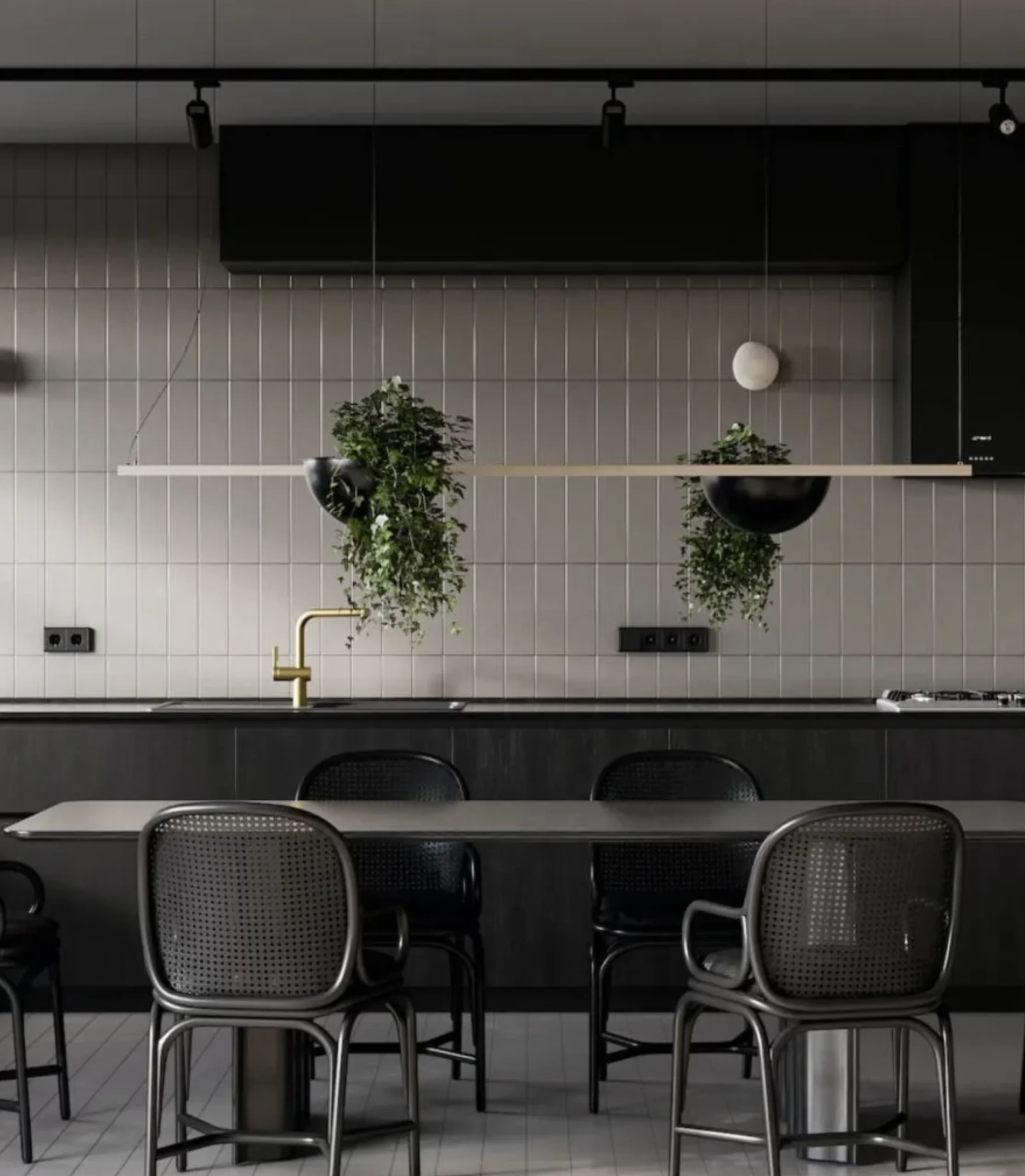 A modern kitchen with black cabinets, a black dining table, and four black chairs. Two hanging planters with green plants are above the table against a backdrop of light gray tiled walls, creating a chic and inviting home atmosphere. Trust Slabmaster to bring this contemporary design to life.