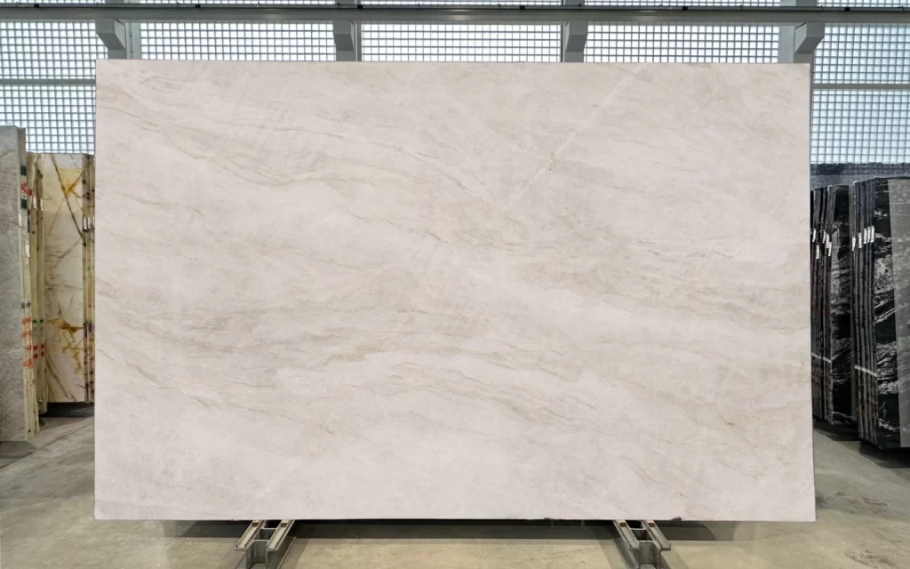 A large slab of white marble with subtle grey veining, reminiscent of the elegance of the Taj Mahal, is displayed upright in Block 3 of the showroom.