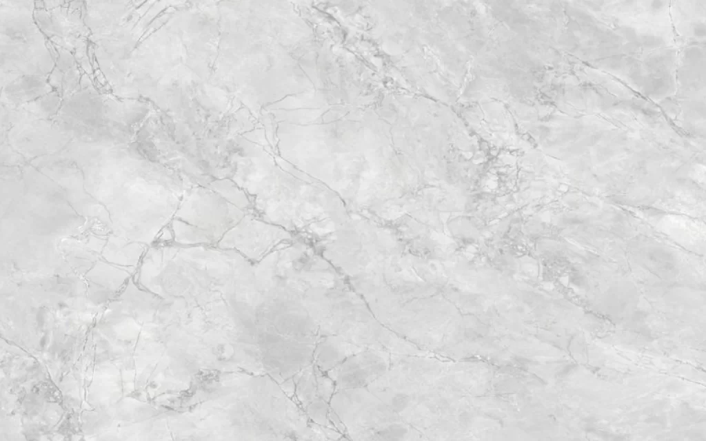 A grey marble surface with natural veining patterns resembles the elegant look of Super White Dolomite, showcasing timeless beauty.