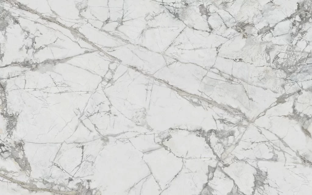 A close-up of an invisible marble surface with grey veining in an irregular pattern.