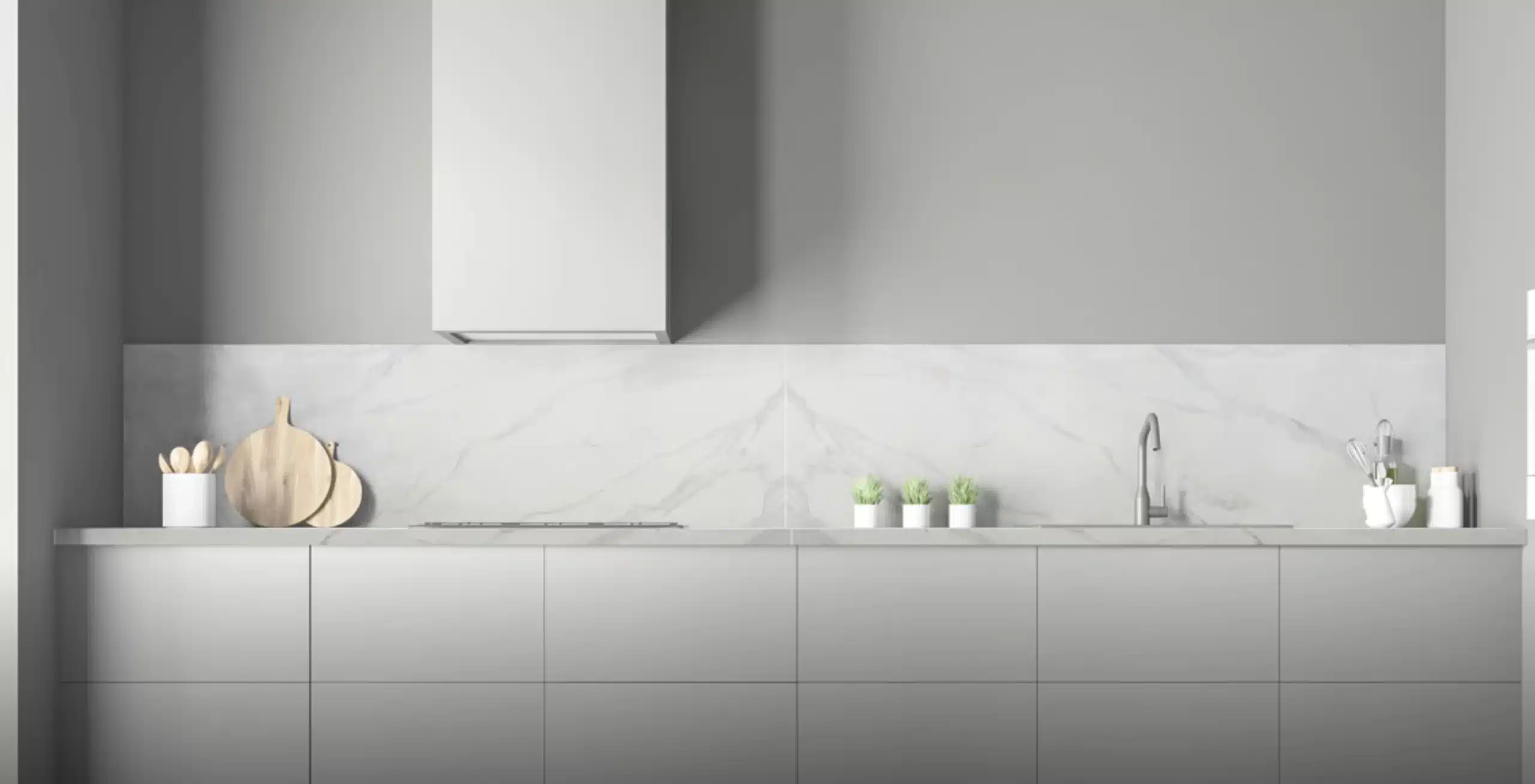 Modern minimalist kitchen with white cabinets, marble backsplash, wall-mounted hood, and countertop with potted plants, a chopping board, and a faucet.