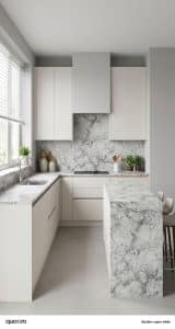 Modern kitchen with white cabinets, Super White Dolomite-patterned countertops and backsplash, large window with blinds, and two stools at a small island.