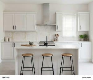 Modern kitchen with Bianca white cabinets, a marble backsplash, a center island with three wooden stools, and a window with blinds above the sink.